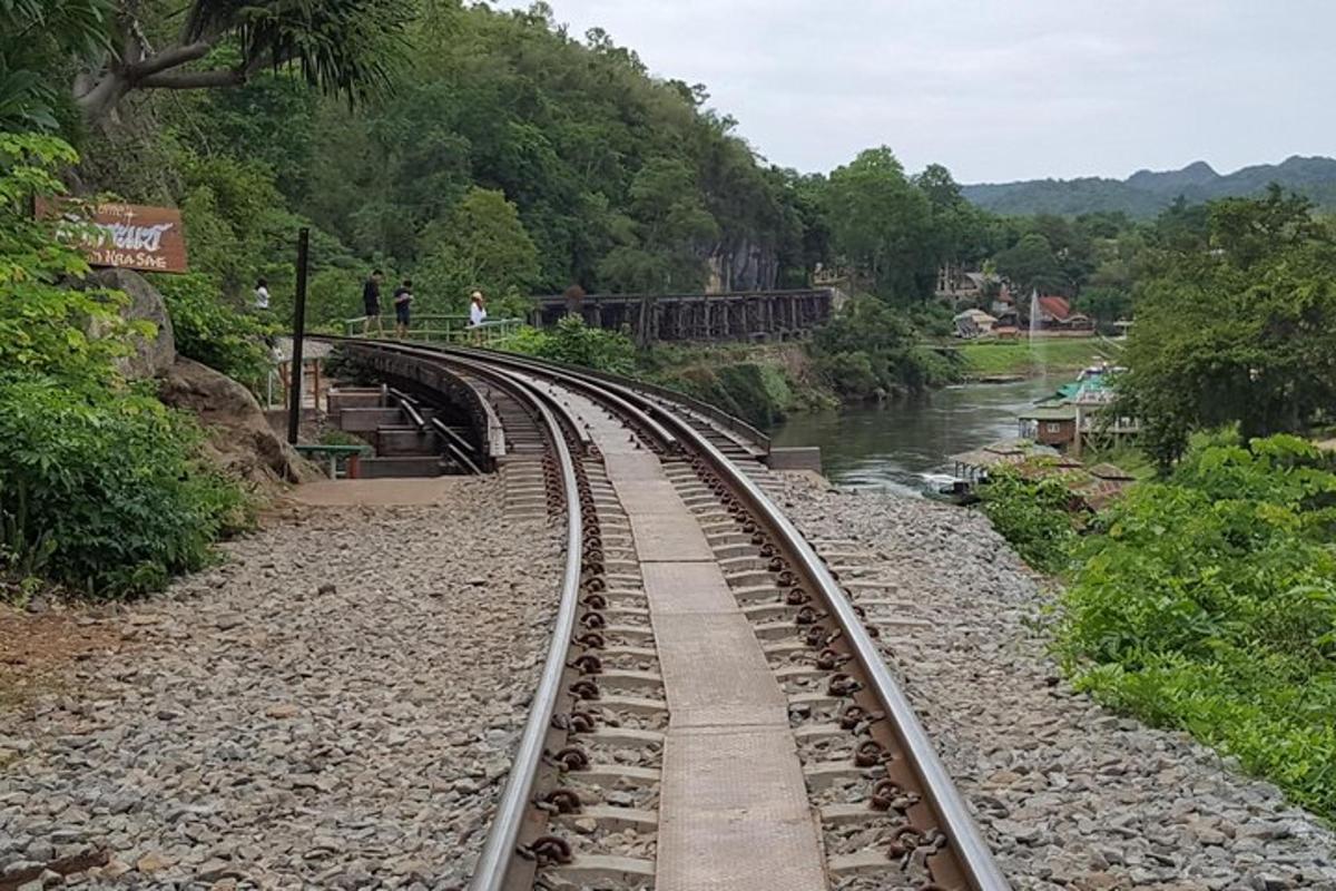 a train track on a bridge over a river