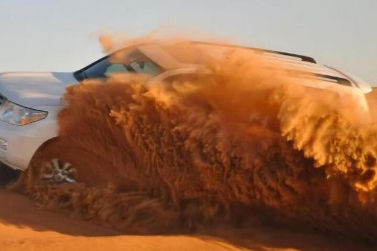 a car in the sand in the desert