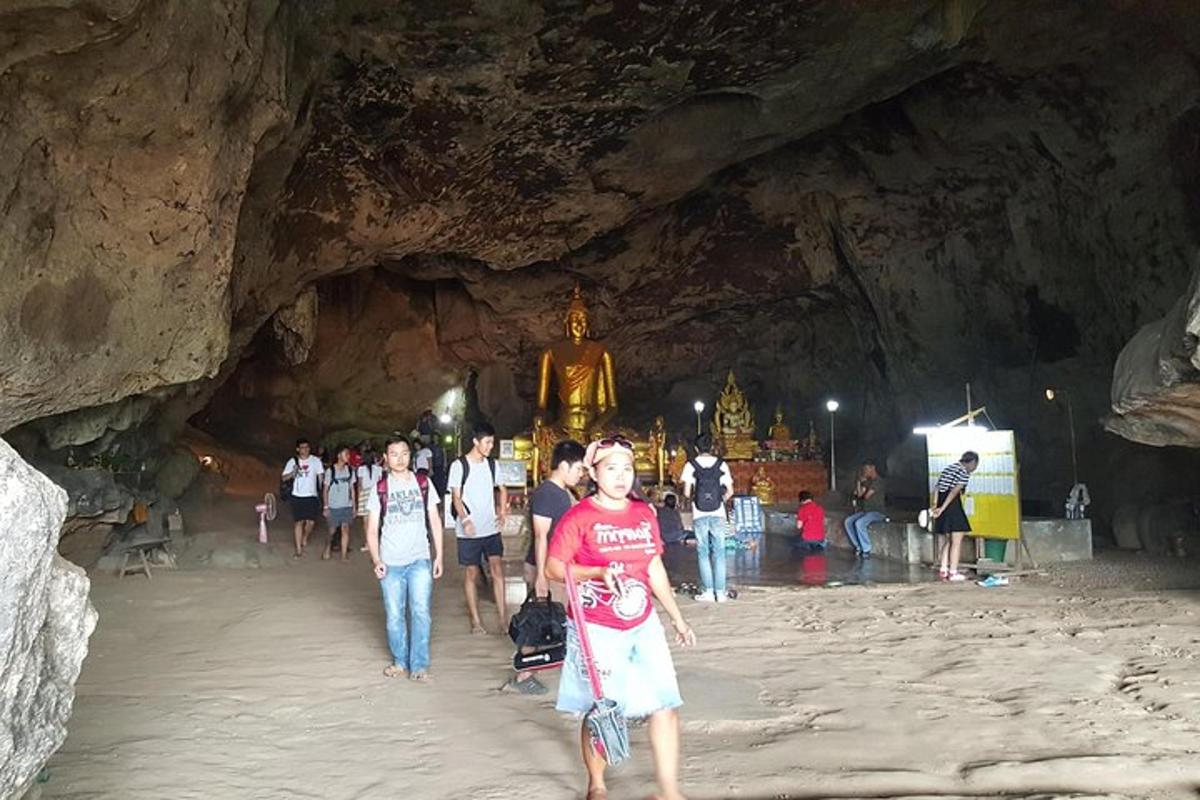 a group of people walking through a cave