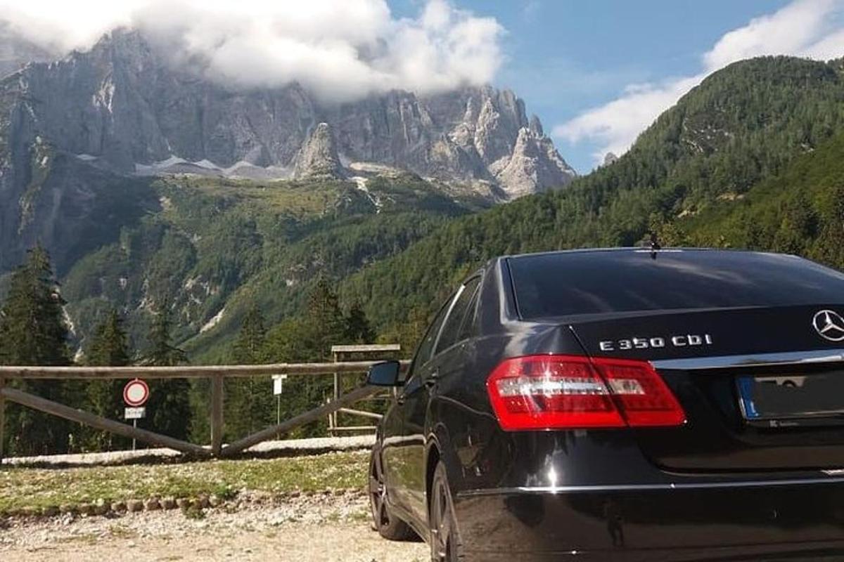 a black car parked on the side of a mountain