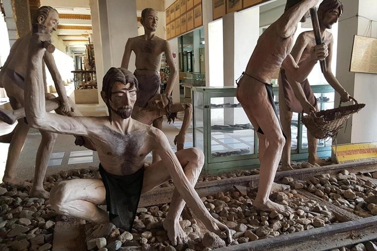 a statue of a group of men on train tracks