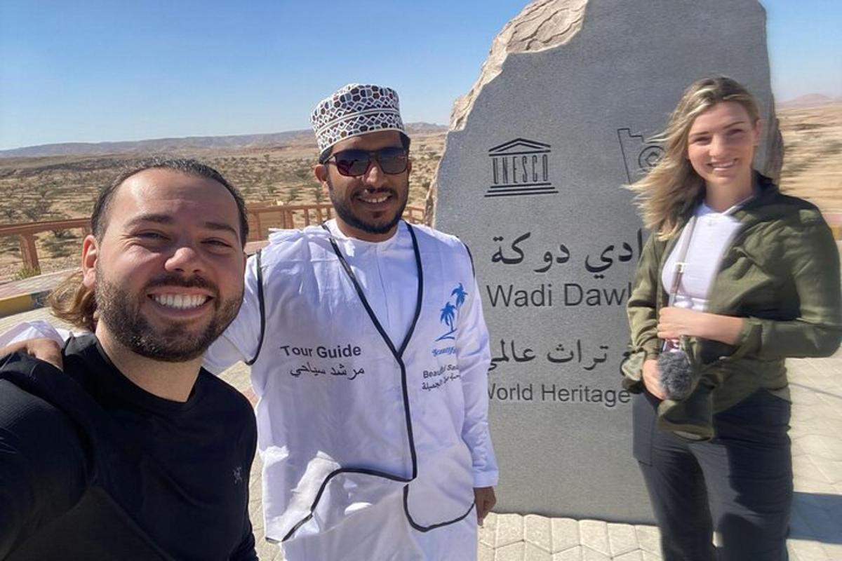 a man and a woman standing in front of a monument