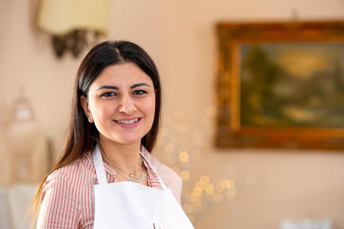 a woman is smiling while holding a piece of paper