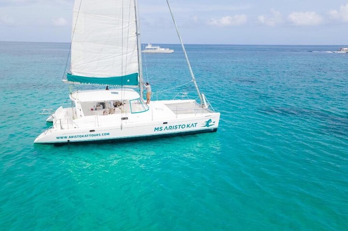 a white sail boat floating in the water