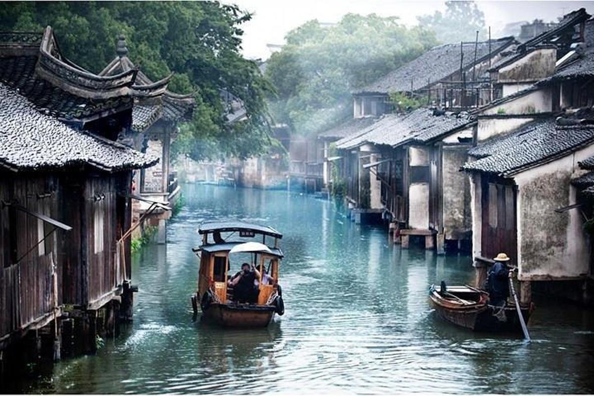 two boats in a river in an asian village