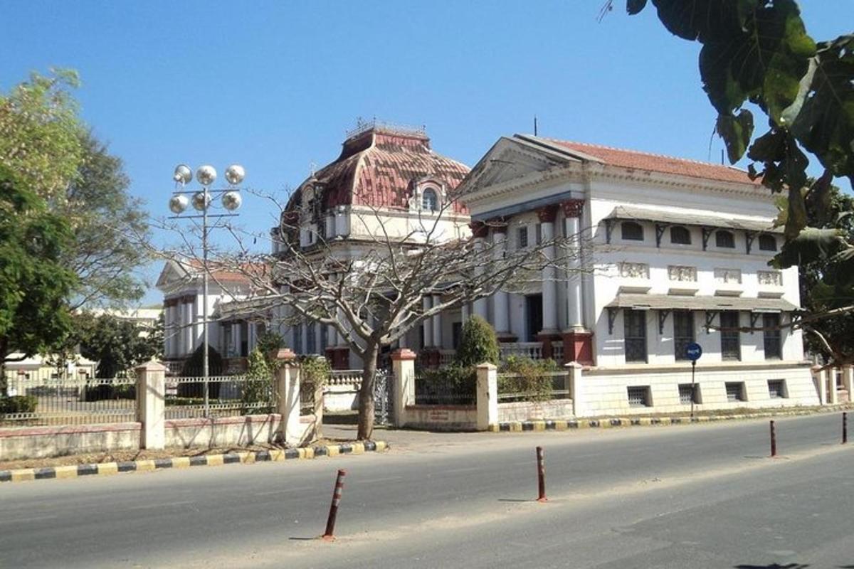 a large white building on the side of a street