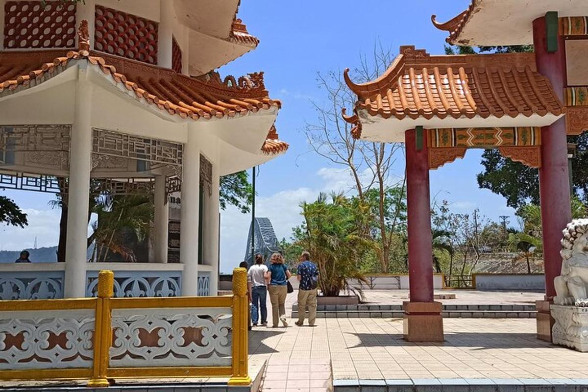 a group of people walking around a pavilion