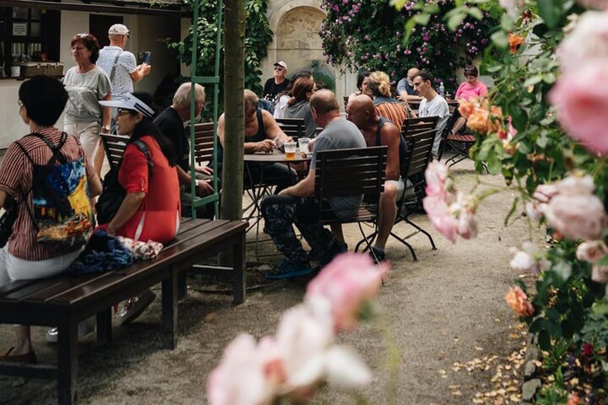 a group of people sitting at tables in a garden