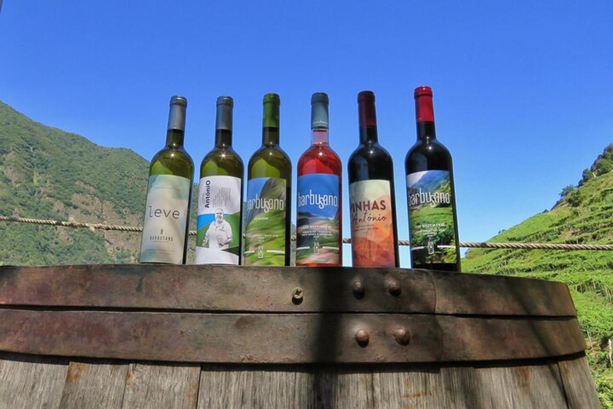a bunch of wine bottles sitting on top of a barrel