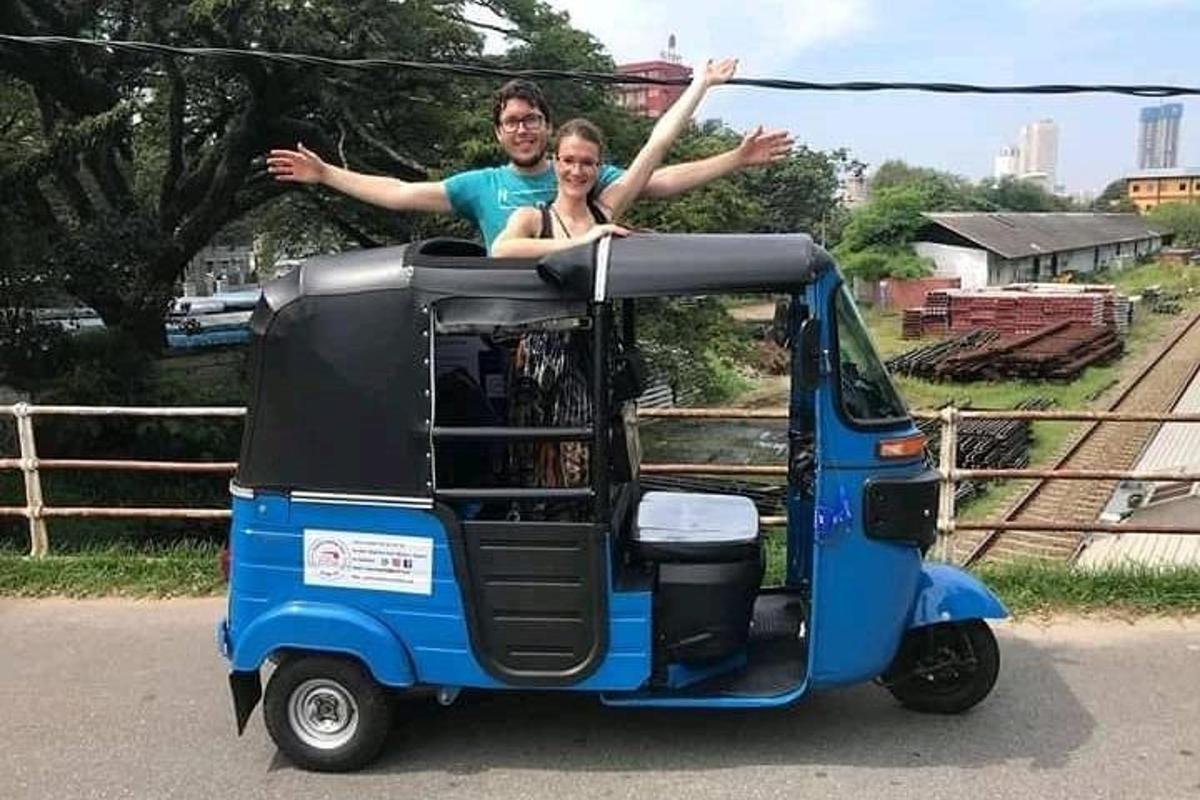 a man and woman are sitting on top of a small vehicle