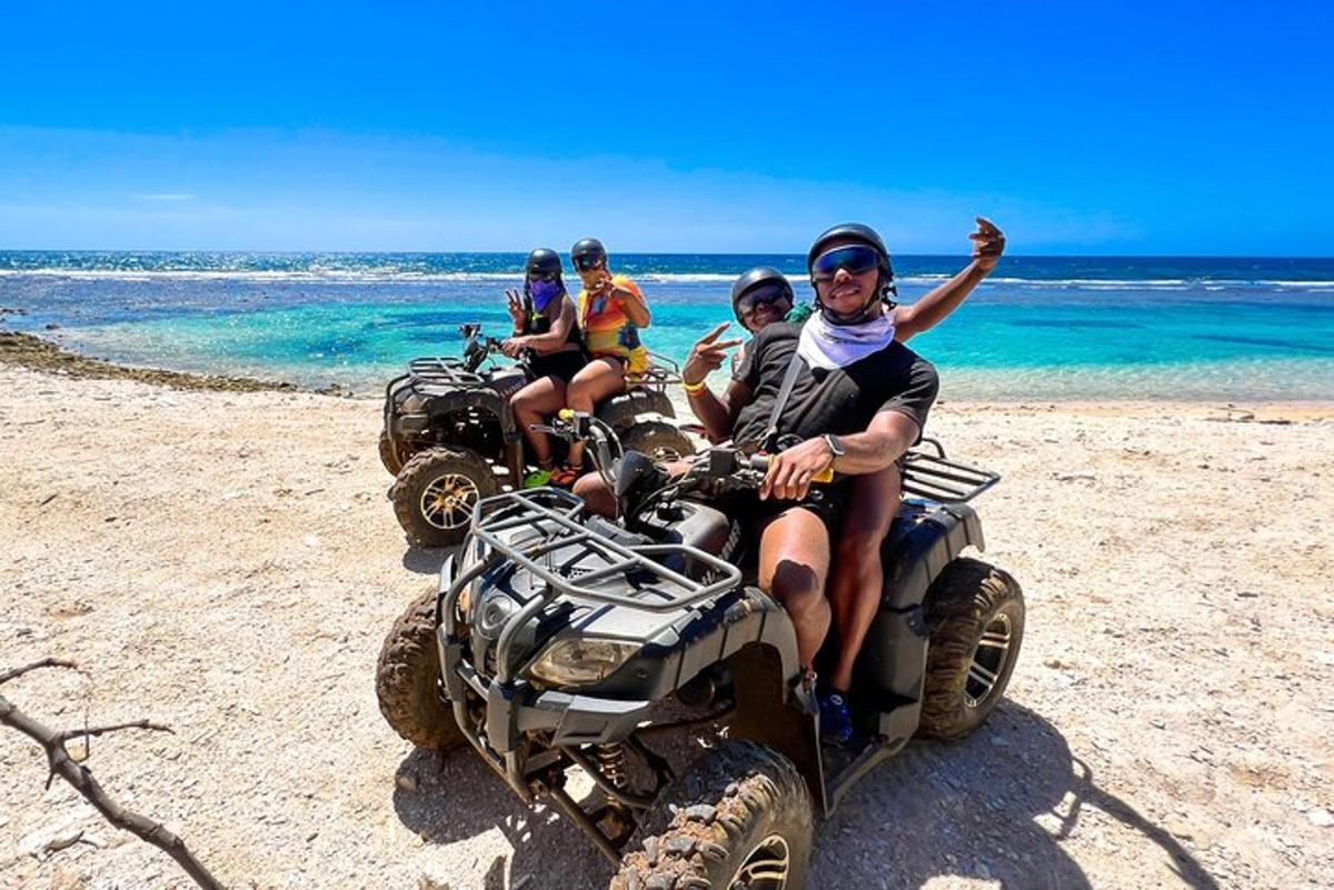a group of people riding atvs on the beach