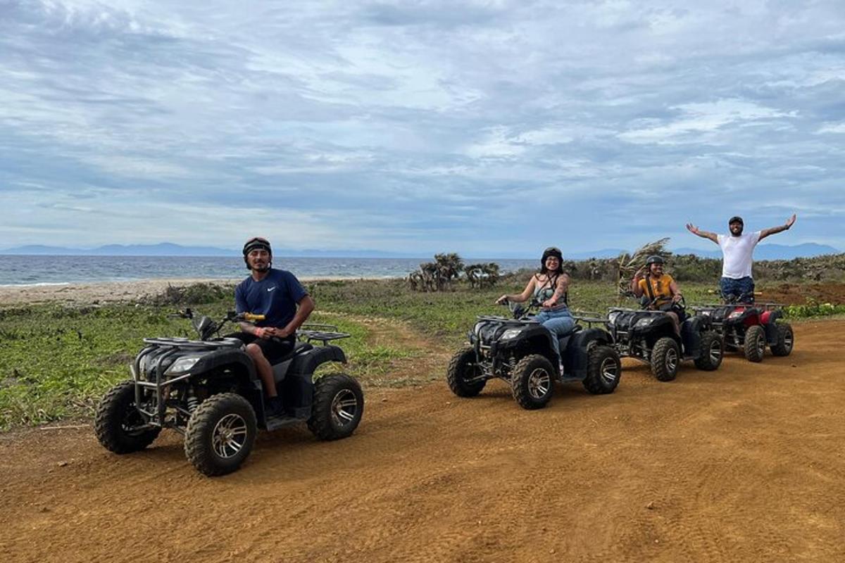 a group of people riding atvs on a dirt road