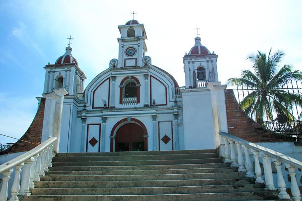 a white church with stairs leading up to it