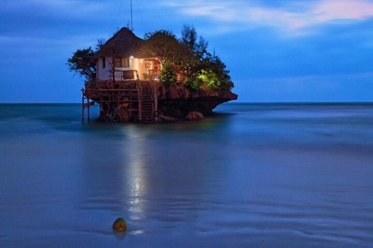 a house on an island in the middle of the water