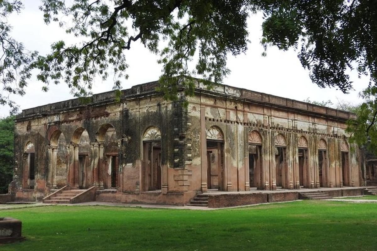 an old stone building with a green lawn