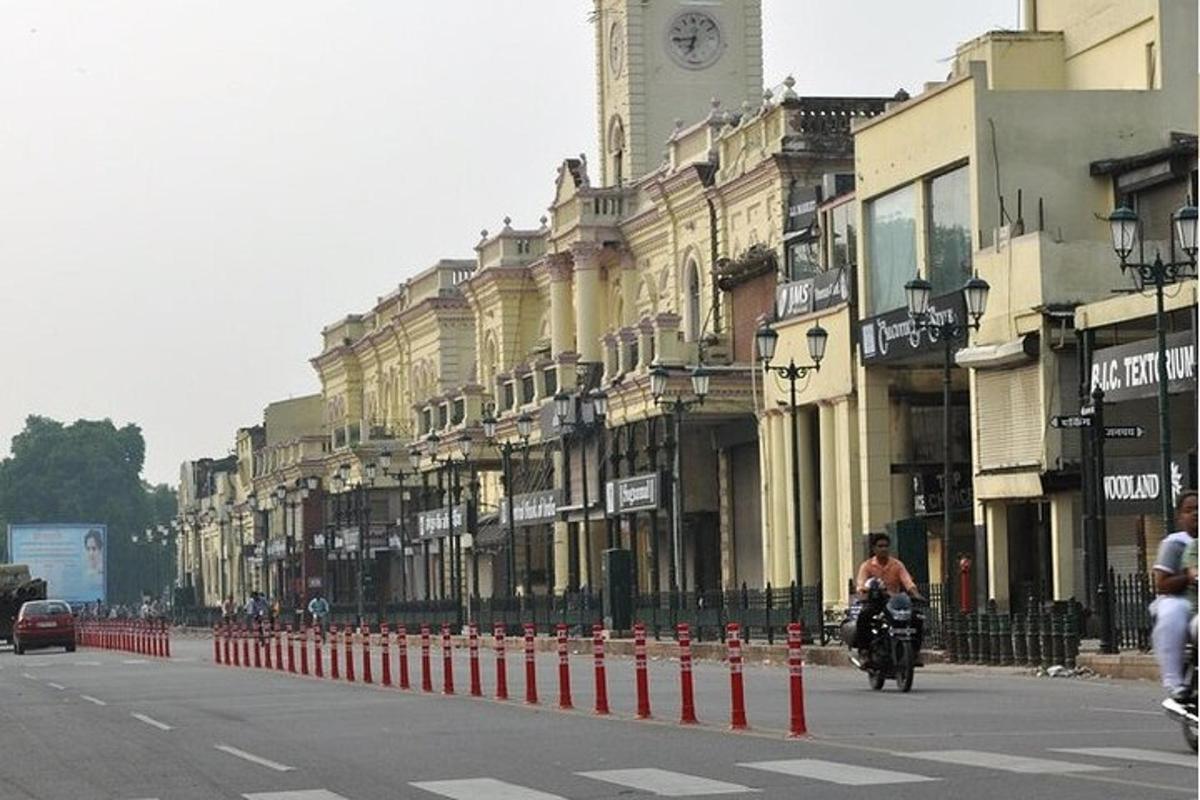 a person riding a motorcycle down a street with buildings