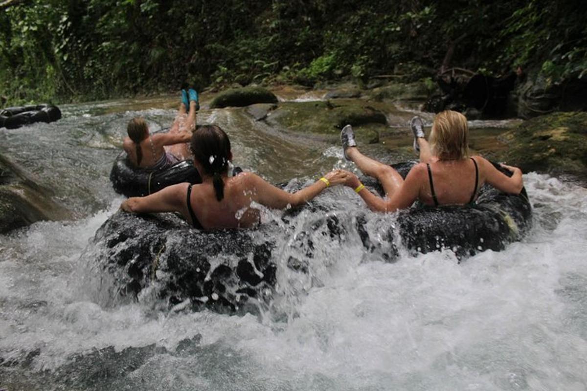 a group of people riding on tubes in the water
