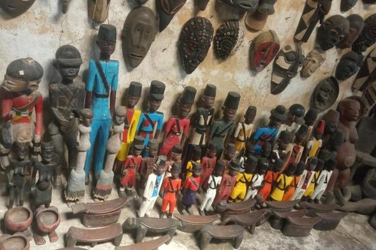 a wall with a bunch of wooden figurines on it