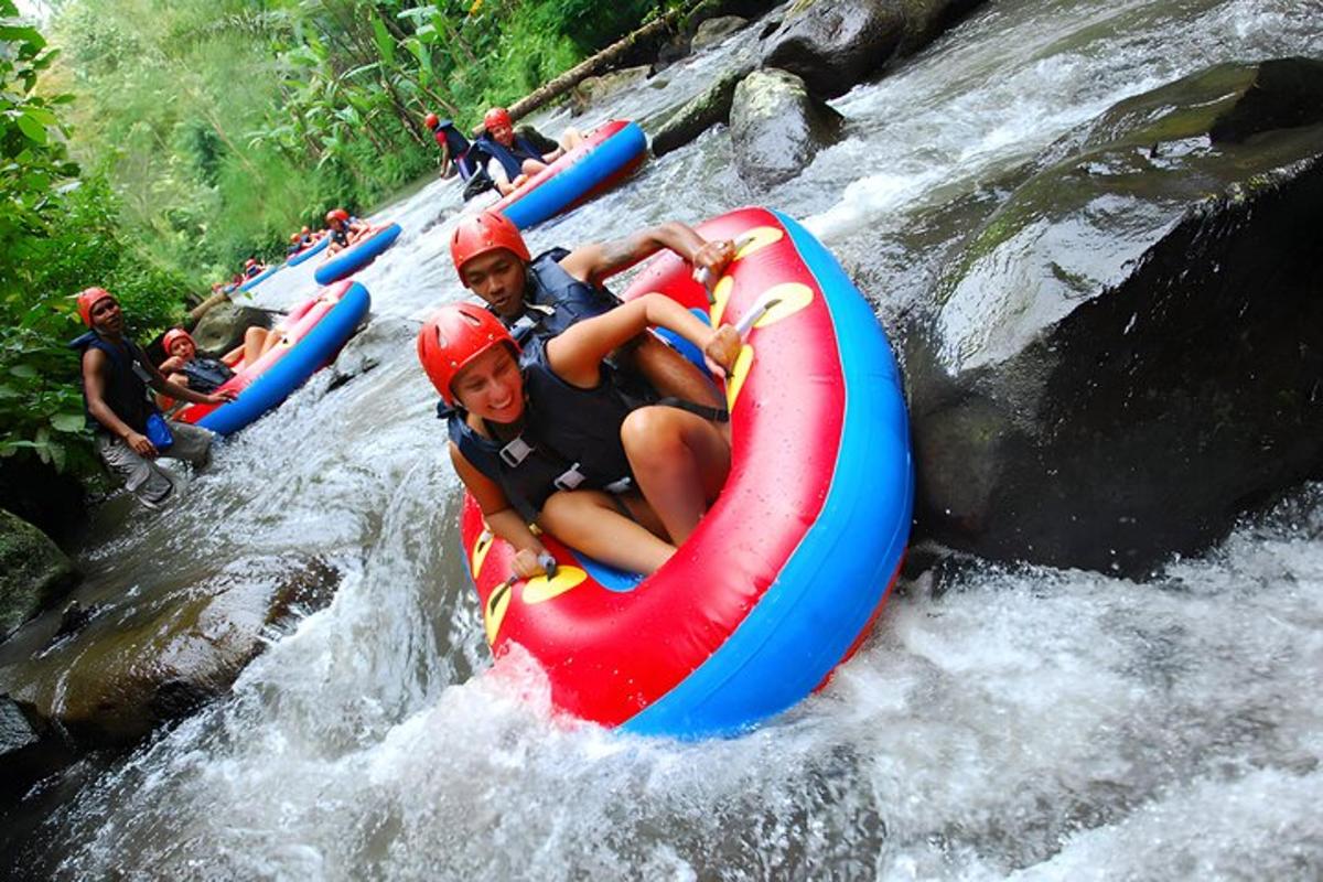 a group of people riding on a raft in a river