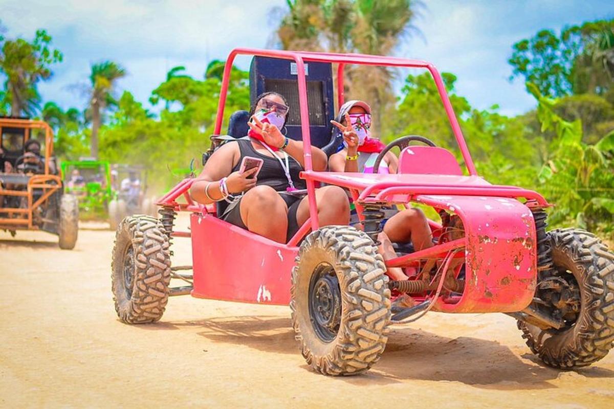two people sitting in a red four wheeler