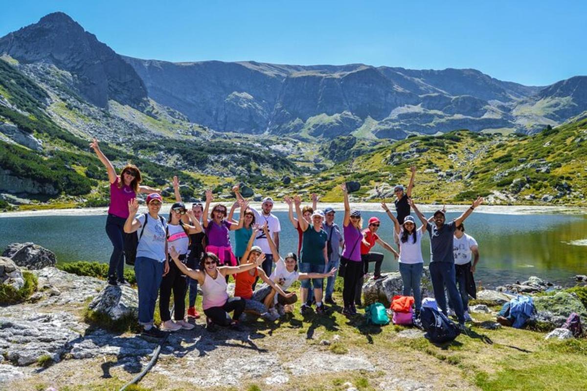 a group of people posing for a picture on a mountain