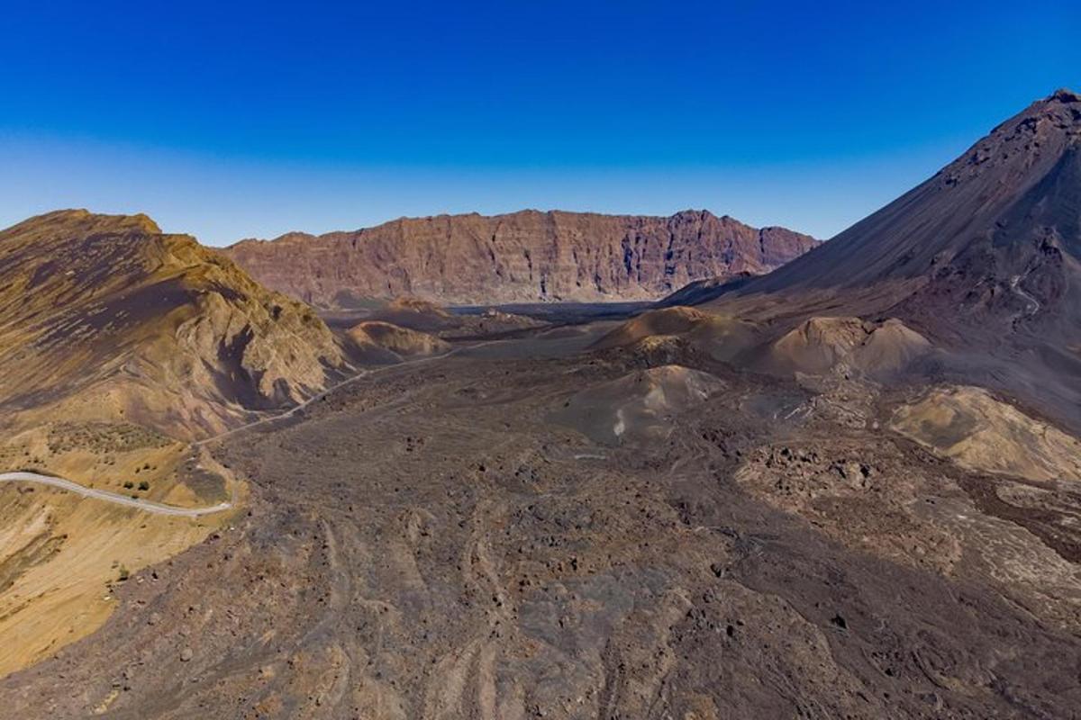 an aerial view of a desert with a mountain