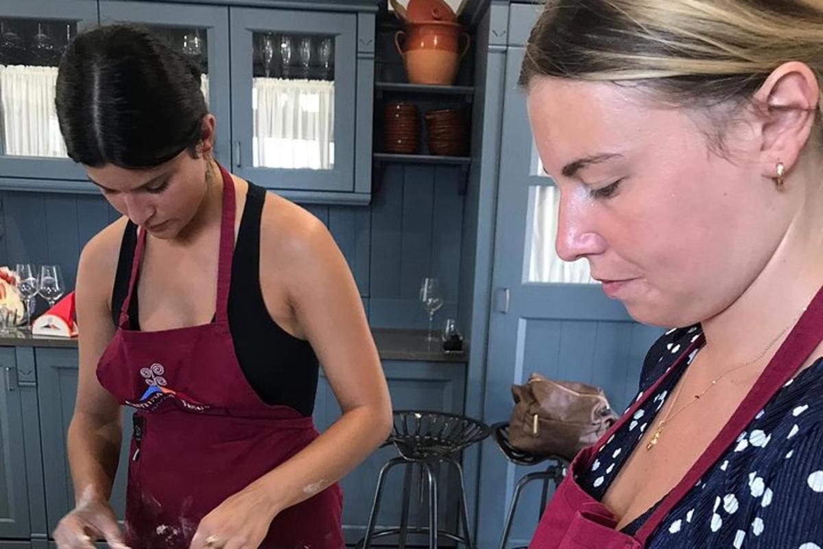 duas mulheres em pé na cozinha preparando comida