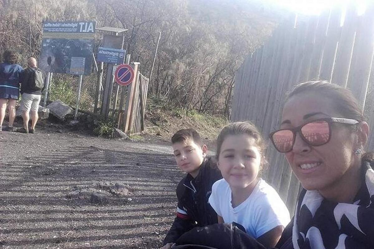 žena a dítě sedící u plotu