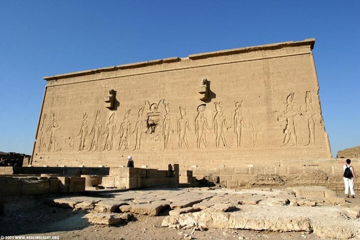 a person standing in front of a large wall