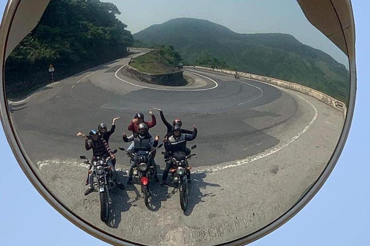 skupina lidí jedoucích na motorkách po klikaté silnici