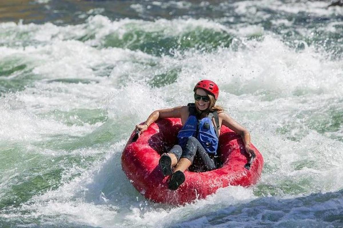 a young girl is riding on a raft in the water