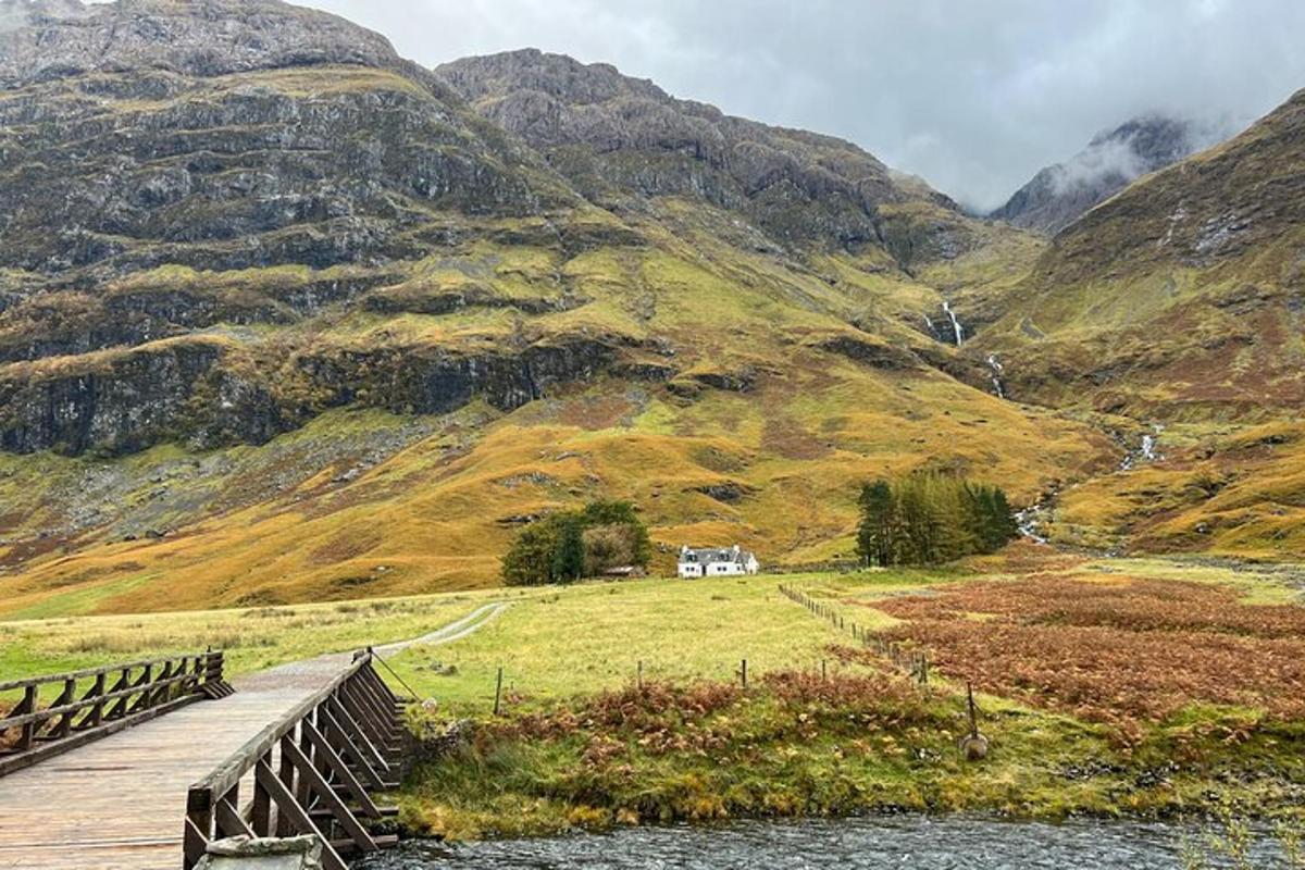 a bridge over a mountain with a house on it