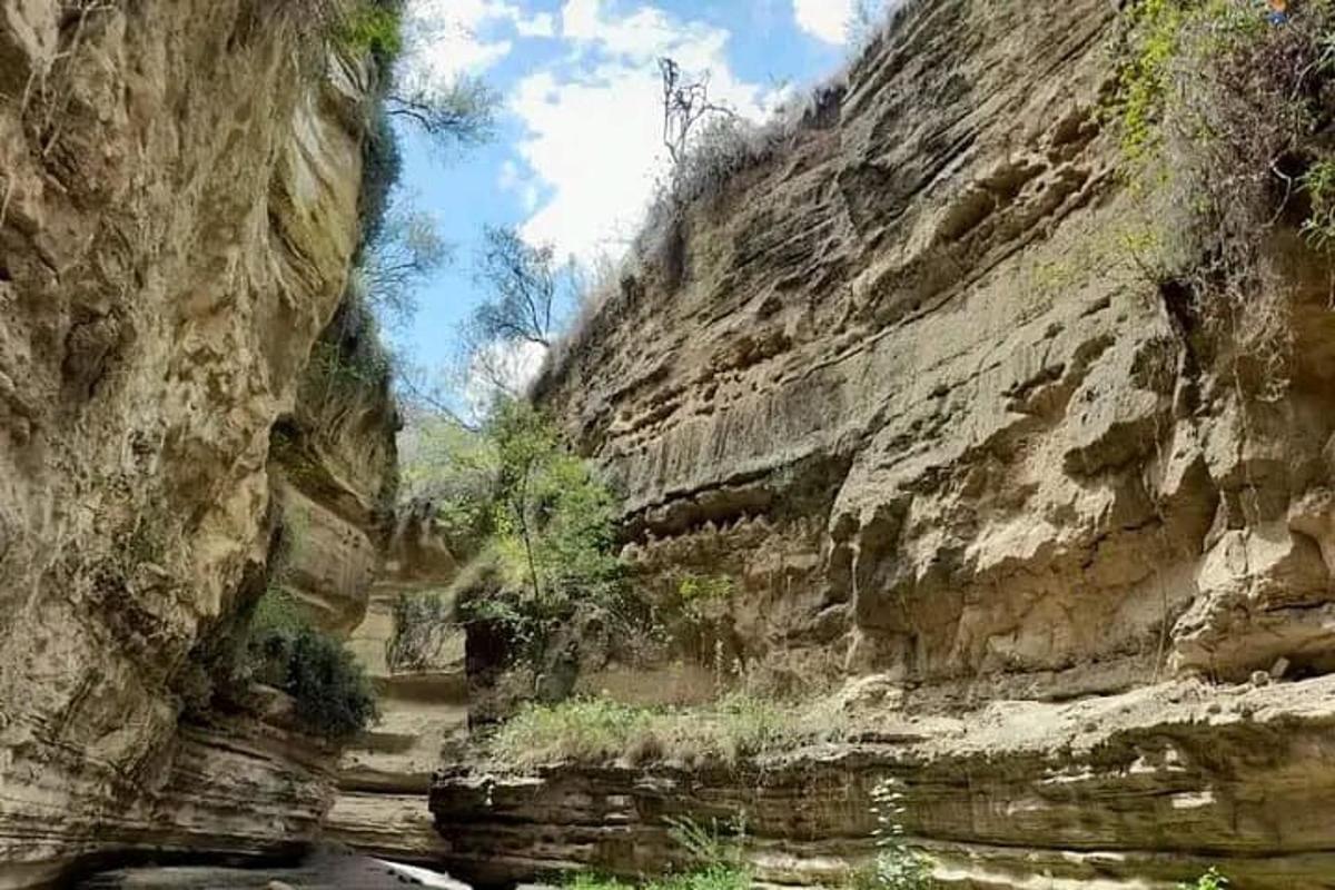 a rocky mountain with a river in a canyon