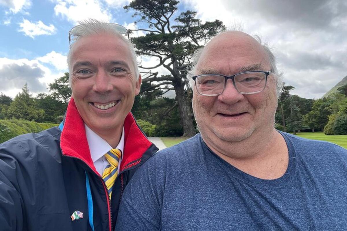 two men are standing next to each other