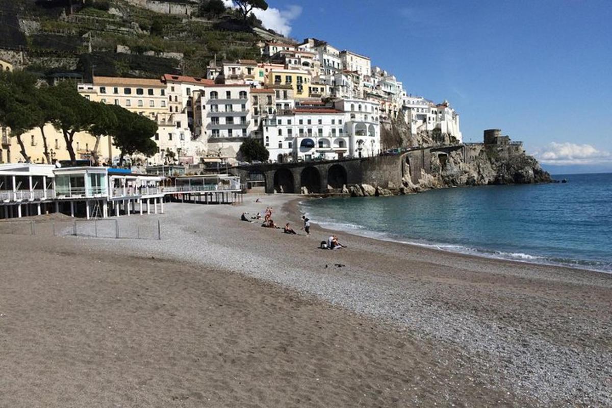 a beach with a group of people sitting on the sand