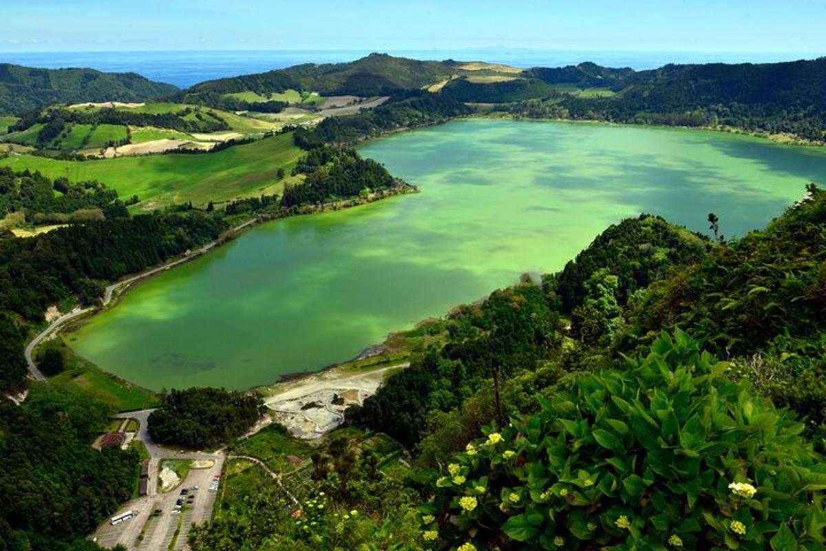 a large green lake in the middle of a valley