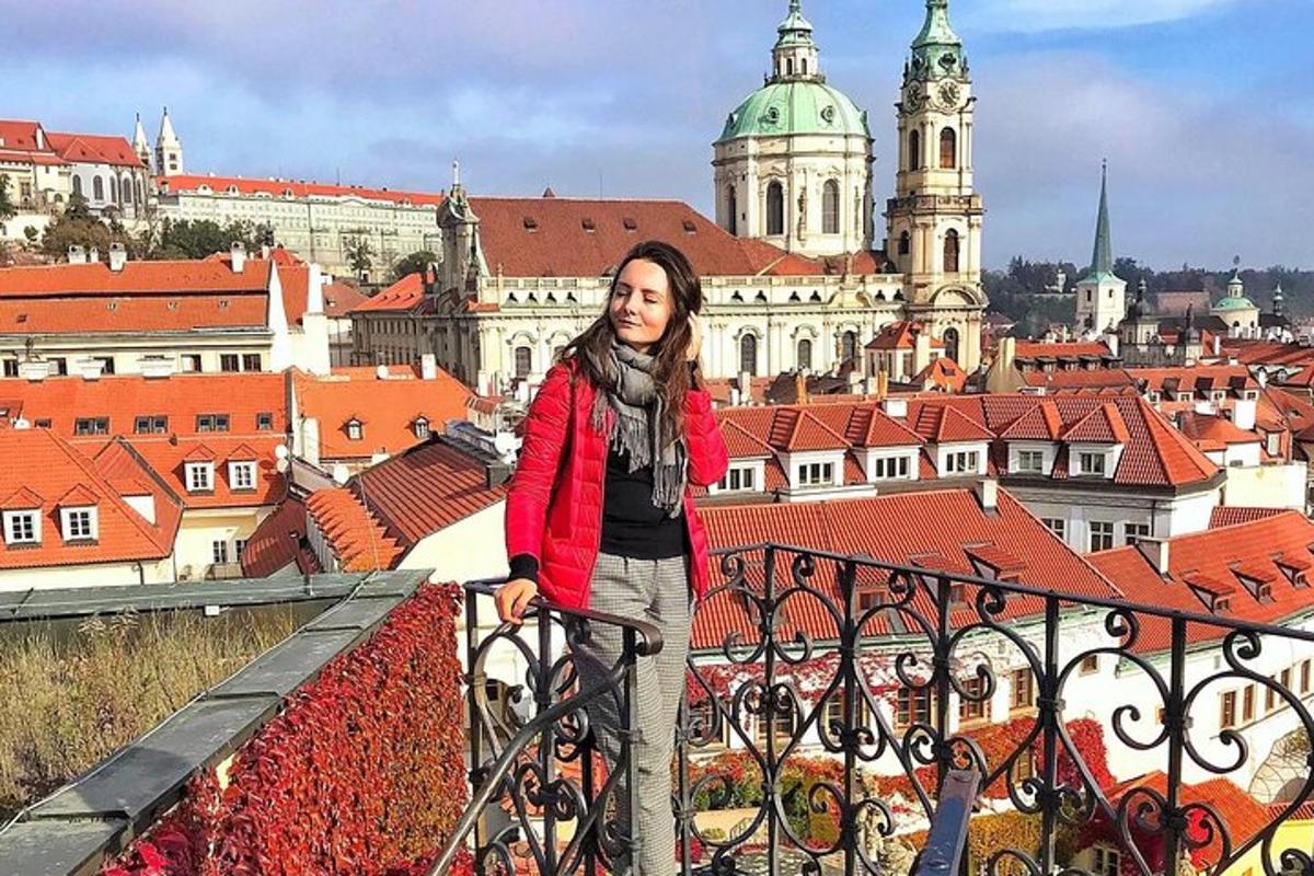 a woman standing on a balcony with a view of a city