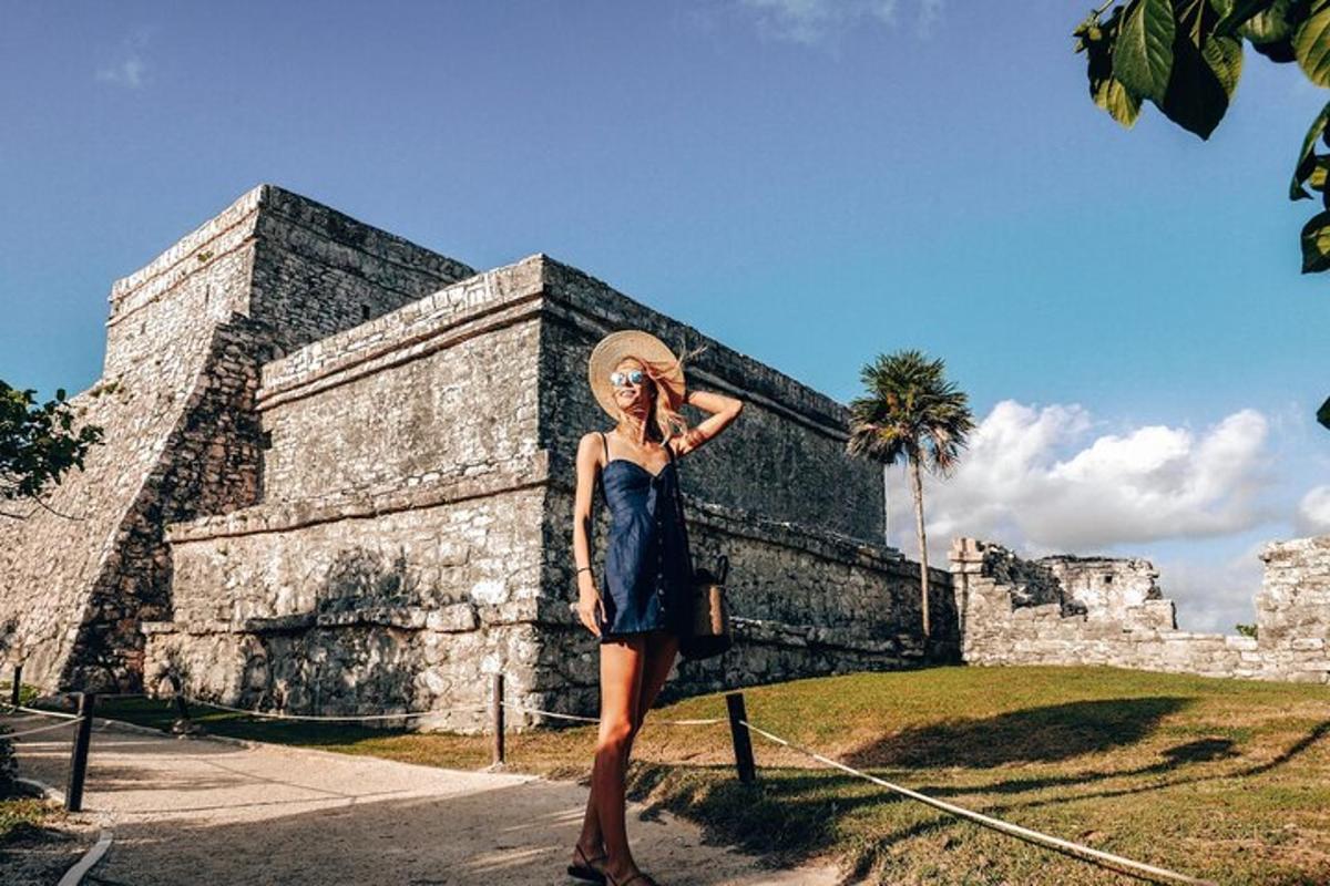 a woman in a blue dress standing in front of a building
