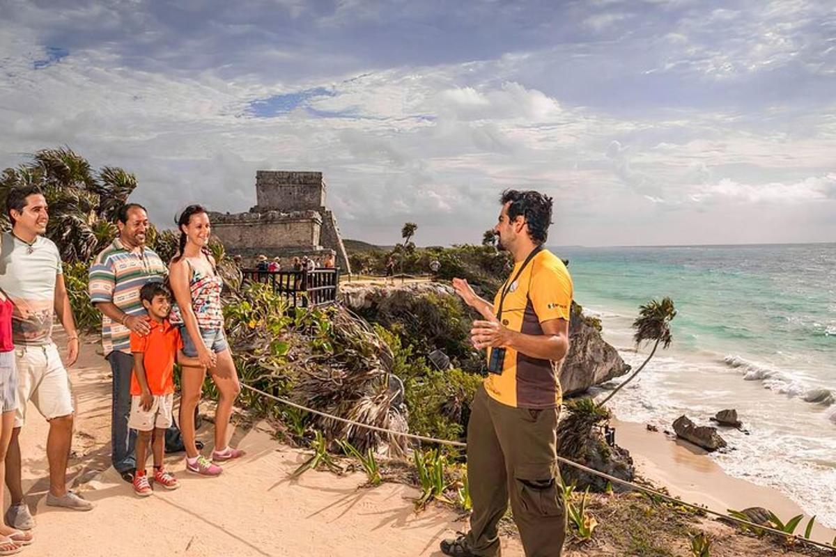 a group of people standing on a beach near the ocean