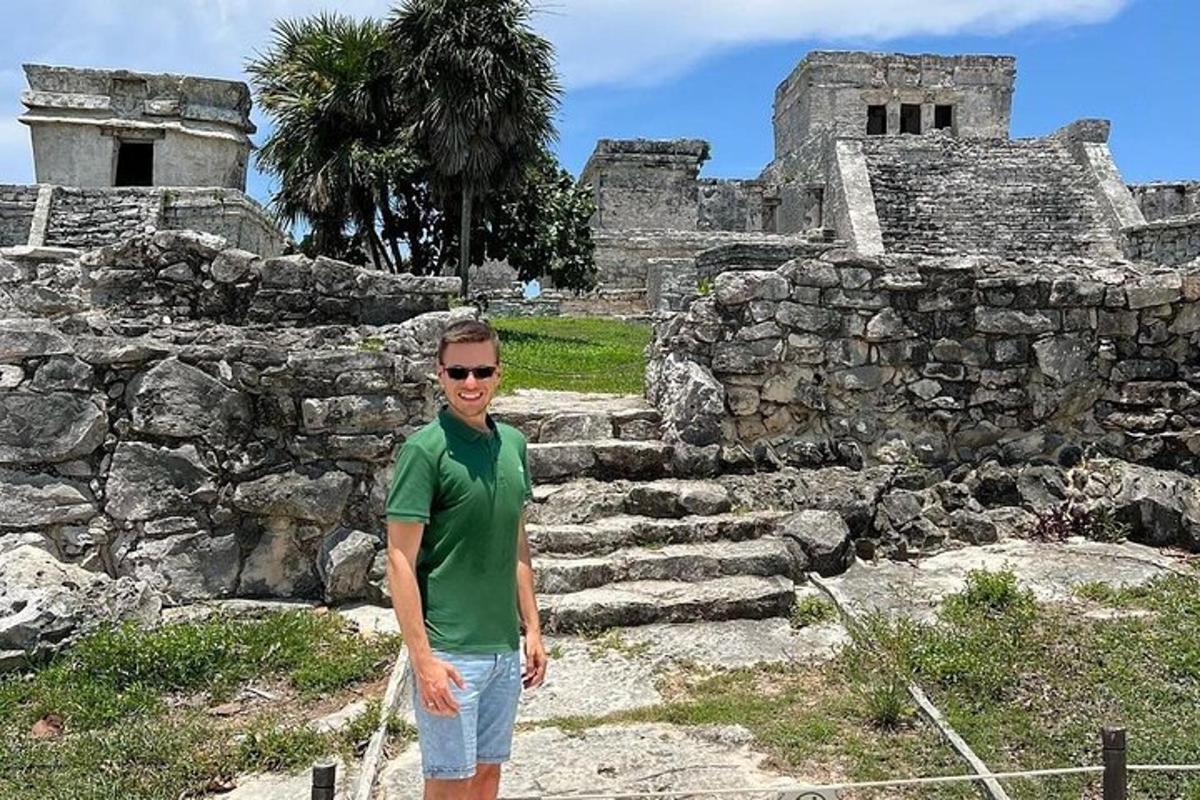 a man standing in front of a stone building