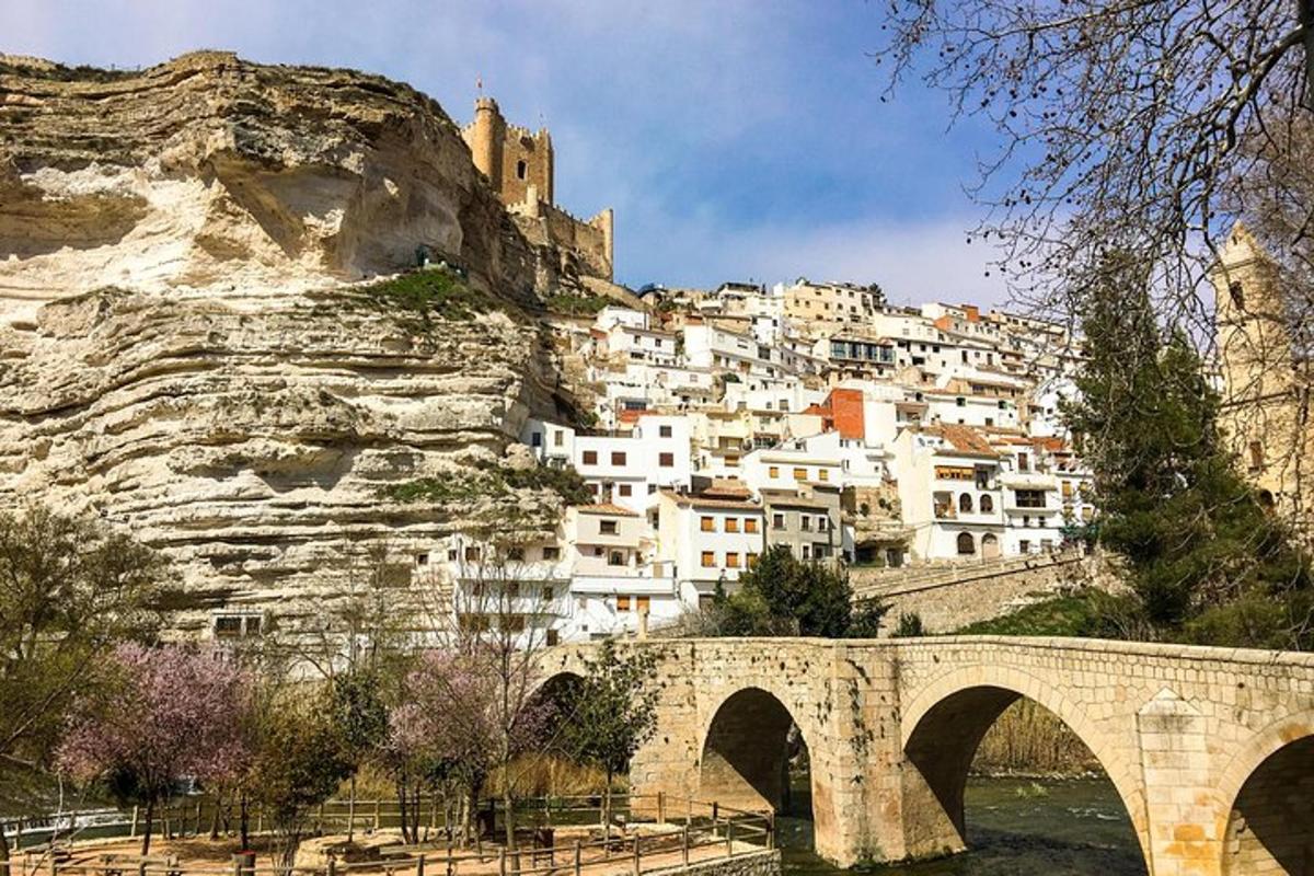 a town on the side of a mountain with a bridge