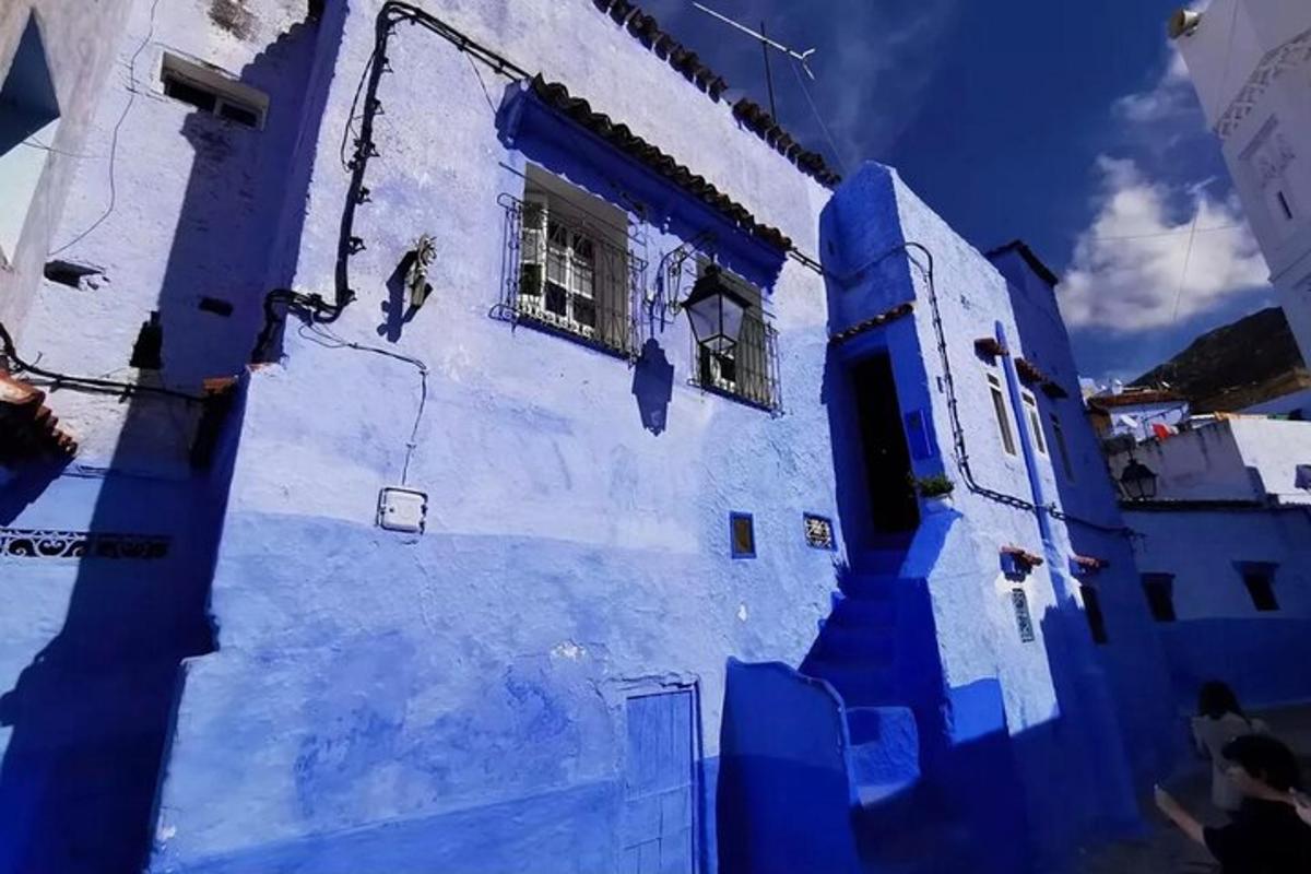 a blue building with windows and a blue wall