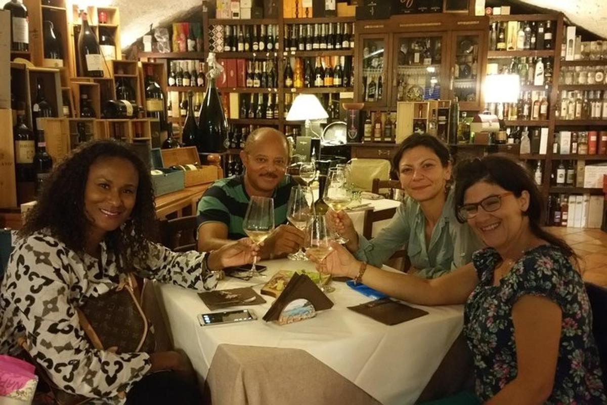 a group of people sitting around a table with wine glasses