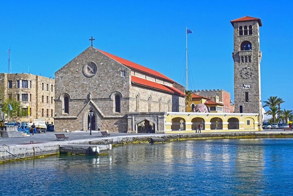 una església amb un campanar al costat d'una massa d'aigua