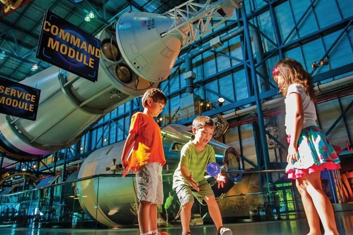 a group of children standing in front of a space shuttle