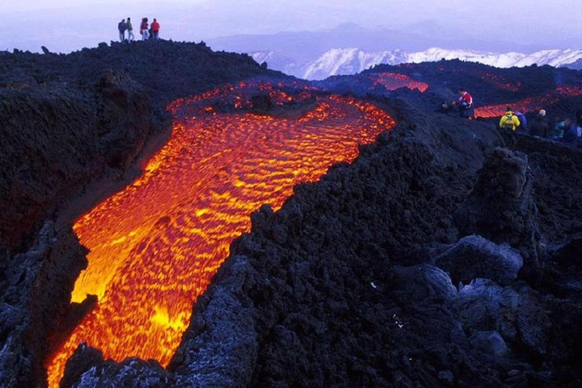 a group of people standing on top of a mountain