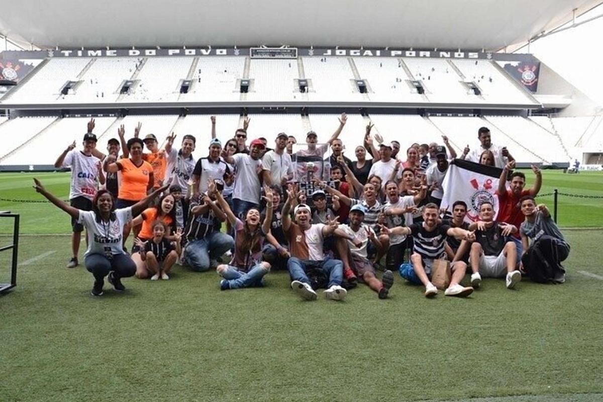 a group of people posing for a picture in a stadium