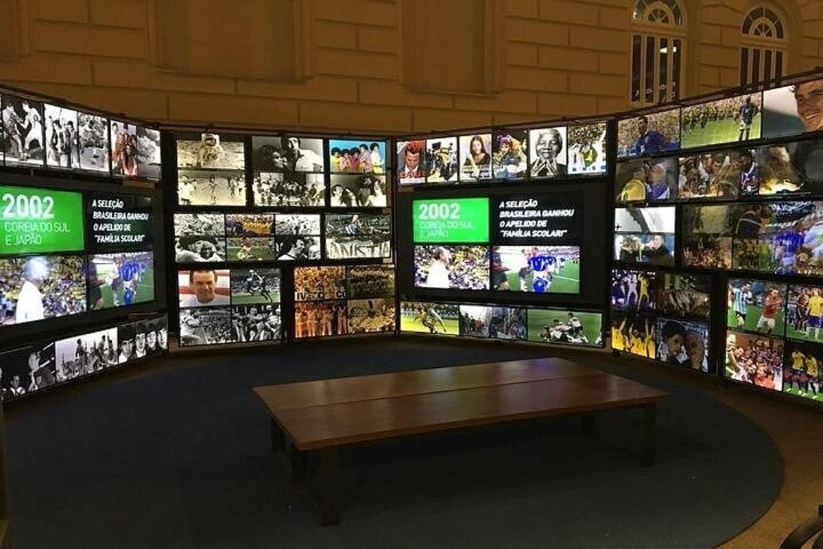 a room with a bench and a bunch of televisions