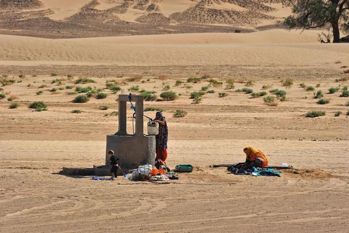 a group of people sitting in the desert