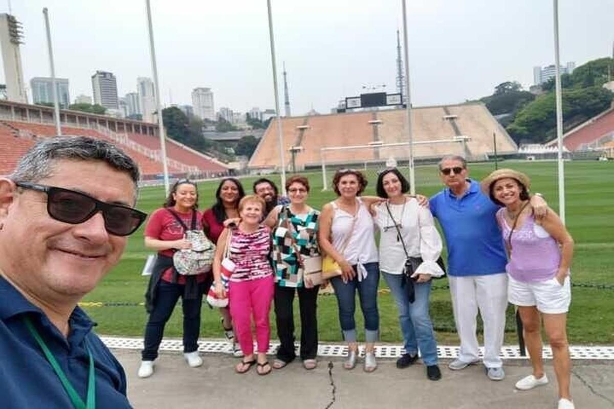 a group of people standing in front of a stadium
